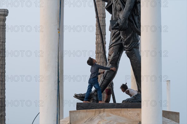 Children at the foot of a Mahatma Gandhi monument, statue, former French colony of Pondicherry or Puducherry, Tamil Nadu, India, Asia