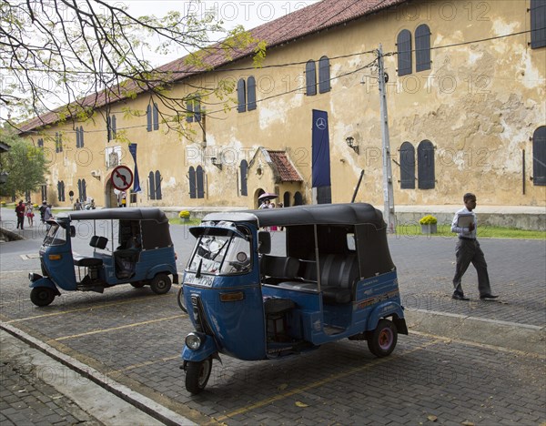 Motor rickshaw known as tuk-tuks inside the fort area of historic town of Galle, Sri Lanka, Asia