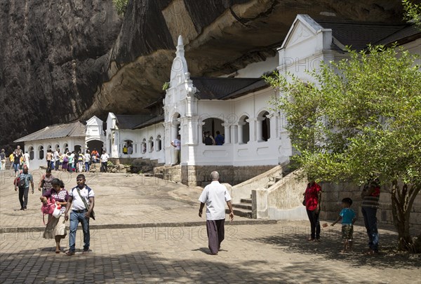 People at Dambulla cave Buddhist temple complex, Sri Lanka, Asia