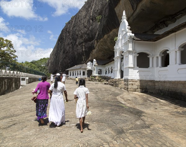 People at Dambulla cave Buddhist temple complex, Sri Lanka, Asia