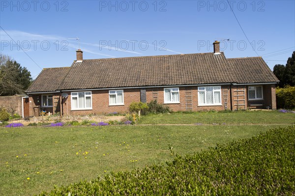 Semi-detached bungalow housing in village of Sutton, Suffolk, England, UK