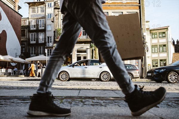 Street full of life, commuters, tourists, cars in a move in Porto, Portugal, Europe