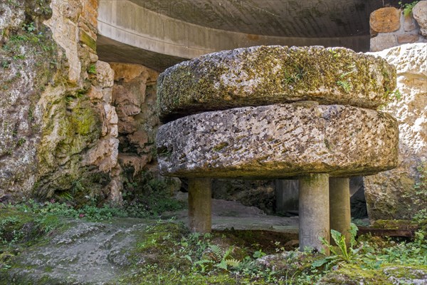 Old millstones in the Trou des Fees at the village Chassepierre near Florenville in the province of Luxembourg, Belgian Ardennes, Wallonia, Belgium, Europe