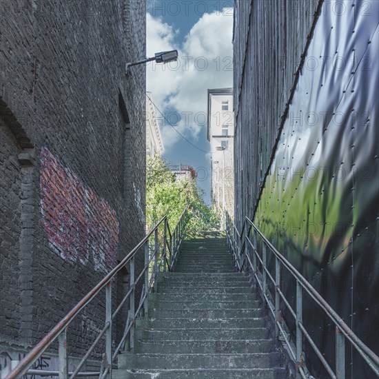 Urban scene with a staircase between two buildings and graffiti wall, Wuppertal Elberfeld, North Rhine-Westphalia, Germany, Europe