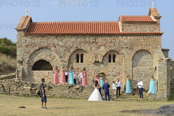 Wedding party posing in front of the Church of St Anthony, Cape Rodon, Albania, Europe