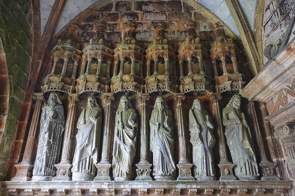 Statues of the apostles in front of the side portal, Enclos Paroissial enclosed parish of Guimiliau, Finistere Penn ar Bed department, Brittany Breizh region, France, Europe