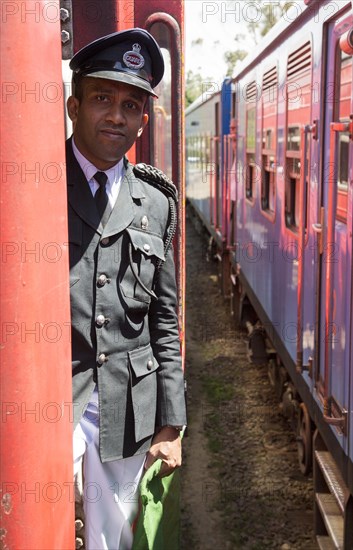 Male railway guard standing on a train Sri Lanka, Asia