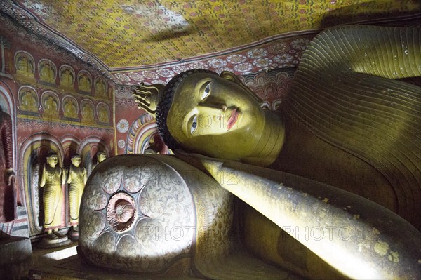 Buddha figure inside Dambulla cave Buddhist temple complex, Sri Lanka, Asia