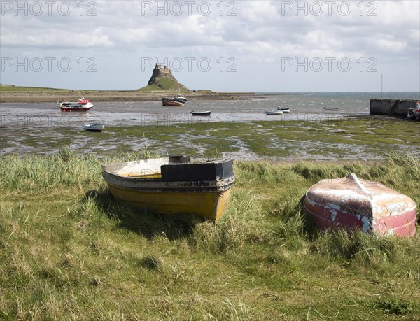 Castle and boats at low tide, Holy Island, Lindisfarne, Northumberland, England, UK