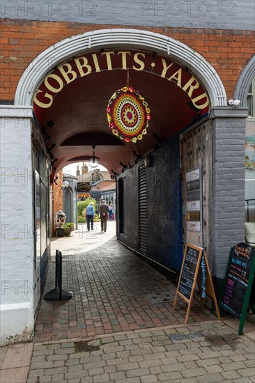 Entrance to Gobbitt's Yard shopping area, High Street, The Thoroughfare, Woodbridge, Suffolk, England, UK