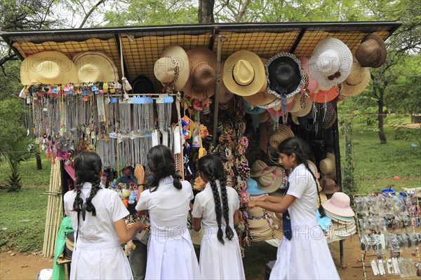 School girls browsing souvenir stall, Polonnaruwa, North Central Province, Sri Lanka, Asia