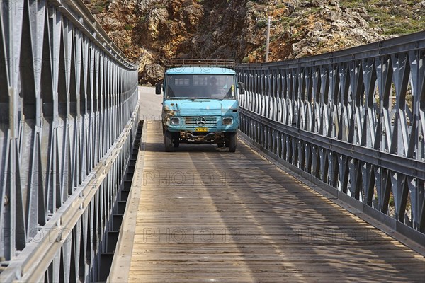 A blue lorry drives over a bridge in mountainous surroundings, Aradena Gorge, Aradena, Sfakia, Crete, Greece, Europe