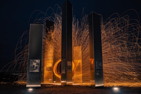 Long exposure with light trails around modern sculptures at night, memorial of the Second World War, Pforzheim, Germany, Europe