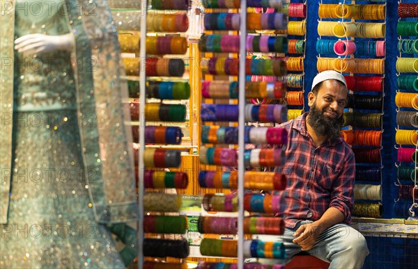 Trader with Hyderabad's famous glass hoops, bazaar, at Charminar, Hyderabad, Andhra Pradesh, India, Asia