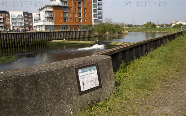 Weir and flood defence wall on the River Orwell, Ipswich, Suffolk, England, UK