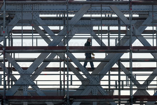 Workers on scaffolding on a riveted steel bridge during painting work in Hamburg's Hafencity, Germany, Europe