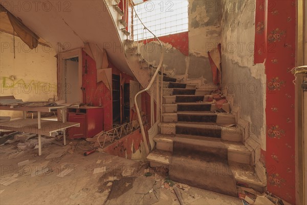 Dilapidated interior staircase of a building with graffiti lettering 'DANGER' on the wall, urologist's villa Dr Anna L., Lost Place, Bad Wildungen, Hesse, Germany, Europe
