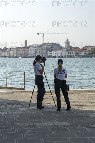 Police laser speed measurement on the island of San Giorgio Maggiore, on the waterfront of the Guidecca Canal, Dorsoduro district, Venice, Veneto, Italy, Europe