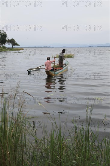 Men fishing from a canoe, Polonnaruwa, Central Province, Sri Lanka, Asia