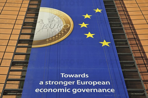 Banner about the euro hanging from the Berlaymont building of the European Commission, executive body of the European Union, Brussels, Belgium, Europe