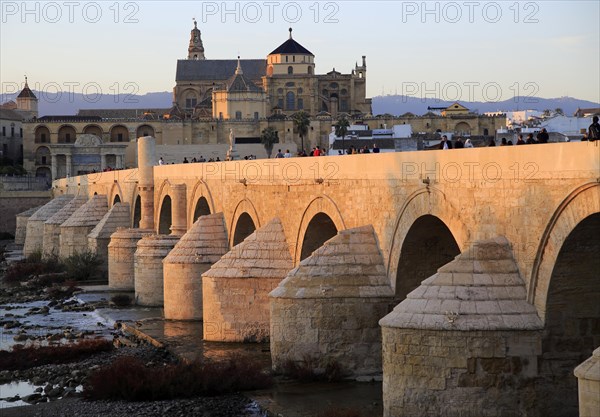 Roman bridge spanning river Rio Guadalquivir with Mezquita buildings, Cordoba, Spain, Europe