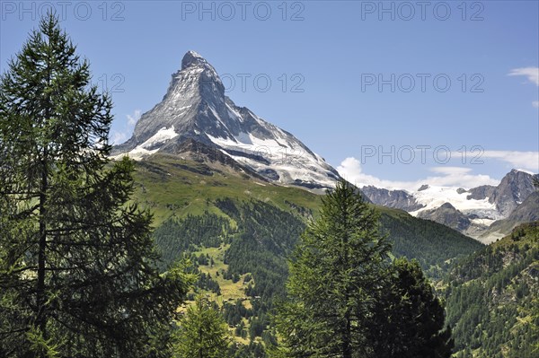 View over the Matterhorn mountain with alpine meadows and pine forests in the Swiss Alps, Valais, Switzerland, Europe