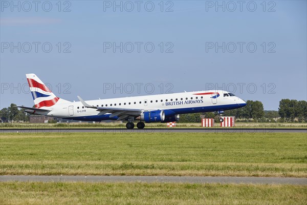 British Airways CityFlyer Embraer E190SR with registration G-LCYR lands on the Polderbaan, Amsterdam Schiphol Airport in Vijfhuizen, municipality of Haarlemmermeer, Noord-Holland, Netherlands