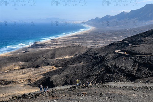 View from viewpoint Mirador di Cofete on surf in front of beach of East Atlantic Atlantic landscape of extinct primeval volcanoes volcanic landscape of old lava on west coast of peninsula Jandia of Fuerteventura island, Cofete, Fuerteventura, Canary Islands, Spain, Europe