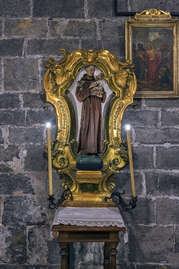 Figure of a saint in a gold frame in the church of San Donato, Via S. Donato, 10, in the centre of Genoa, Italy, Europe