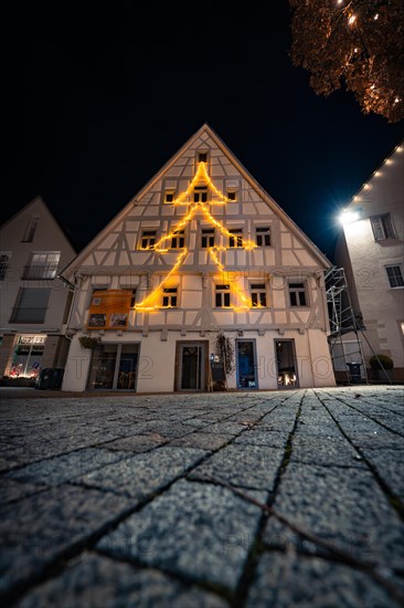 Half-timbered house with Christmas lights in the shape of a fir tree at night, Nagold, Black Forest, Germany, Europe