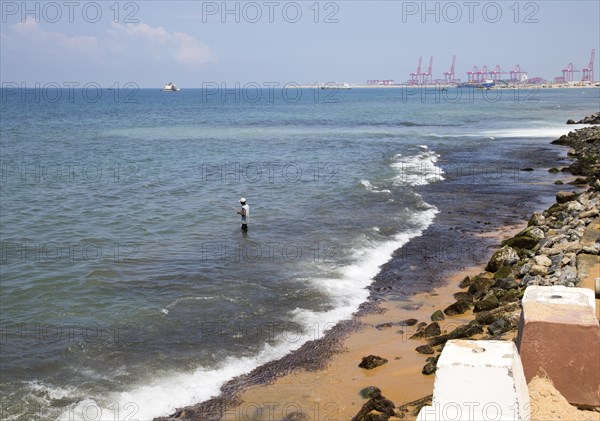 Man fishing in the sea near the Galle Face hotel, Colombo, Sri Lanka, Asia