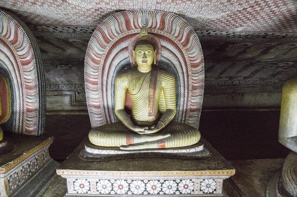 Buddha figure inside Dambulla cave Buddhist temple complex, Sri Lanka, Asia