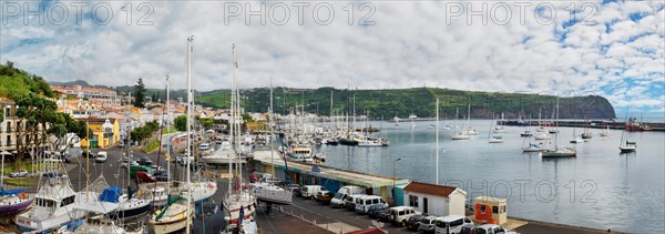 Panoramic view of a busy marina of Horta with boats and surrounded by hilly landscape, Horta, Faial Island, Azores, Portugal, Europe