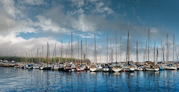 Reflection of sailboat masts in the water of the marina of Horta, Horta, Faial Island, Azores, Portugal, Europe