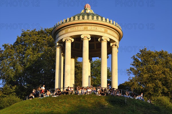 People enjoying the autumn sun at the Monopteros in the English Garden, Munich, Bavaria, Germany, Europe