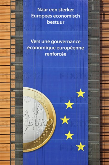 Banner about the euro hanging from the Berlaymont building of the European Commission, executive body of the European Union, Brussels, Belgium, Europe