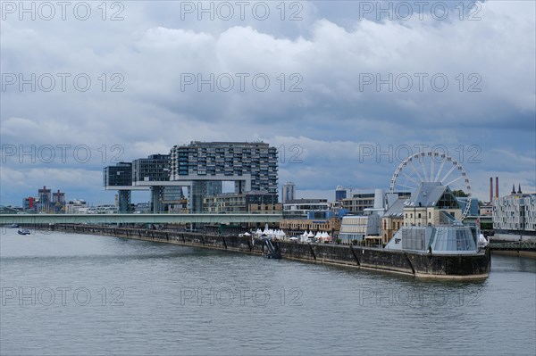 View over the Rhine with crane houses and Ferris wheel, Cologne, Germany, Europe