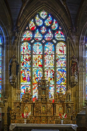 High altar and stained glass windows in the choir of Saint Germain church, Enclos Paroissial de Pleyben enclosed parish dating from the 15th to 17th centuries, Finistere department, Brittany region, France, Europe