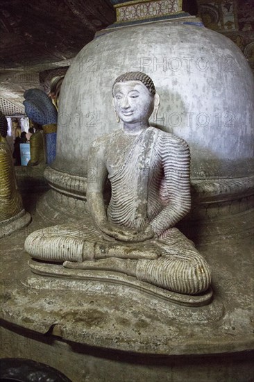 Buddha figure inside Dambulla cave Buddhist temple complex, Sri Lanka, Asia