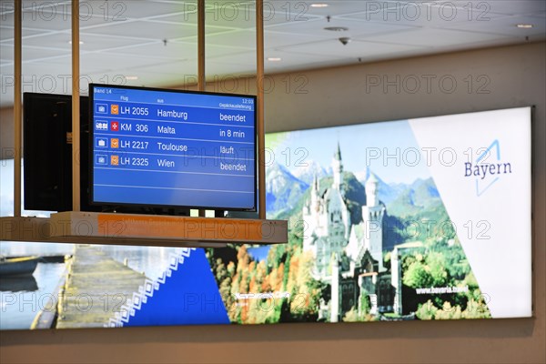 Arrival sign for Lufthansa and Star Alliance partners at the baggage carousel in Terminal 2 with advertising poster for Bavaria with Neuschwanstein Castle, Munich Airport, Upper Bavaria, Bavaria, Germany, Europe