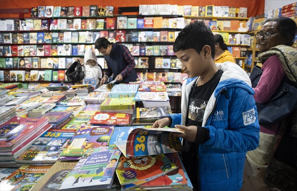 Book readers browsing books at a stall during Assam Book Fair, in Guwahati, Assam, India on 29 December 2023