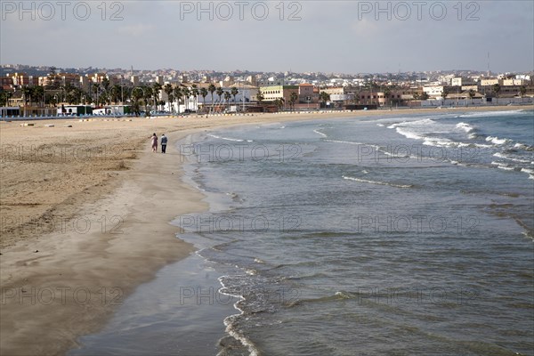 People walking on sandy beach Melilla autonomous city state Spanish territory in north Africa, Spain, Europe