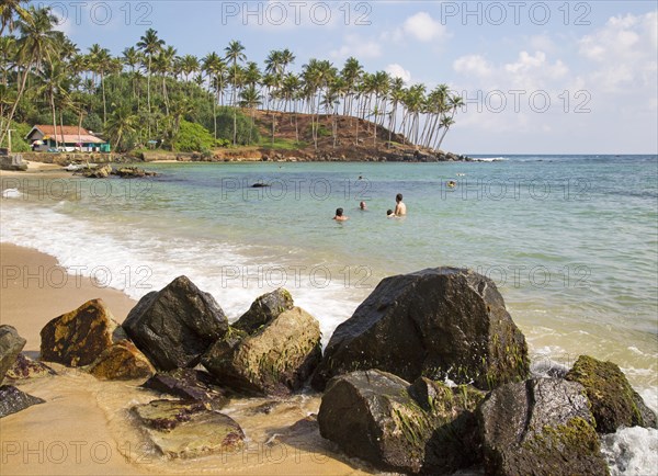 Tropical beach with people swimming Mirissa, Sri Lanka, Asia