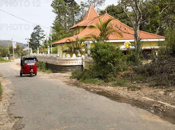 Tuk tuk taxi passing Hindu temple, Haputale, Badulla District, Uva Province, Sri Lanka, Asia