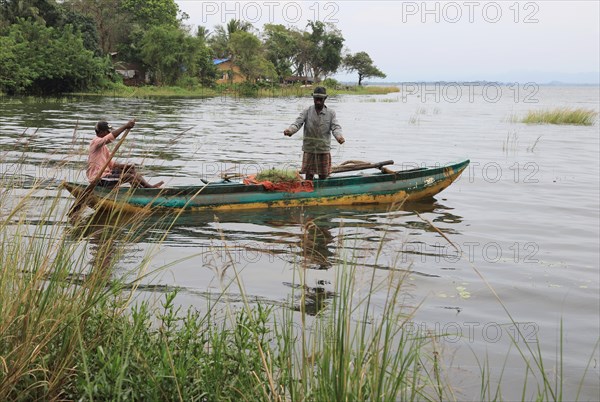 Men fishing from a canoe, Polonnaruwa, Central Province, Sri Lanka, Asia