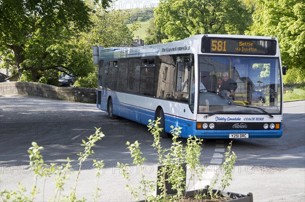 The Craven Connection public transport bus service, in Clapham village, Yorkshire Dales national park, England, UK