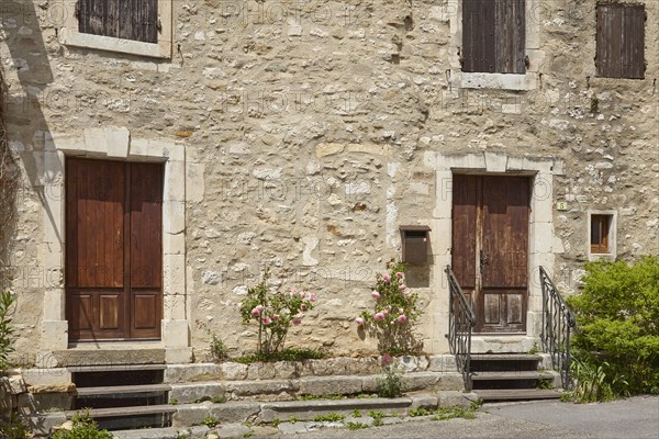 Facades of old houses with doors, windows and shutters in Goudargues, Departement Gard, Occitanie region, France, Europe