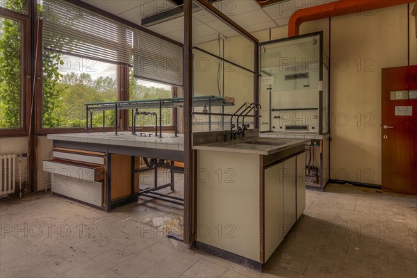 An empty laboratory room with a view of nature through windows, littered with scraps of paper, biotech, abandoned university, lost place, Sint-Genesius-Rode, Belgium, Europe
