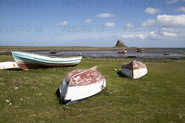 Castle and boats at low tide, Holy Island, Lindisfarne, Northumberland, England, UK