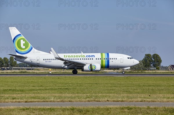 Transavia Boeing 737-7K2 with registration PH-XRY lands on the Polderbaan, Amsterdam Schiphol Airport in Vijfhuizen, municipality of Haarlemmermeer, Noord-Holland, Netherlands